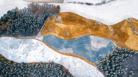 Aerial view of winter landscape with river and forest. Top viewの写真素材