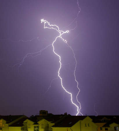 Lighting bolt over houses roofs