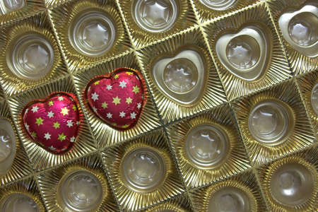 Box with two chocolate candies in shape of heart, a valentine's day gift. Copyspace provided.の写真素材