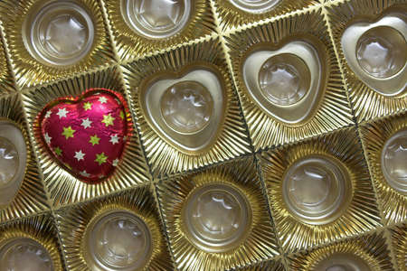 Box with chocolate candy in shape of heart, a valentine's day gift. Copyspace provided.の写真素材
