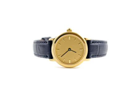 A female golden wrist watch with leather wristlet.の写真素材