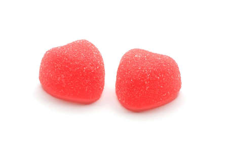 Two strawberry heart-shaped jellies isolated on white background.の写真素材