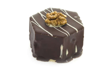 Delicious chocolate cake with walnut isolated on white background.の写真素材