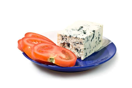 Blue cheese and tomato slices on the plate, isolated on white background.の写真素材