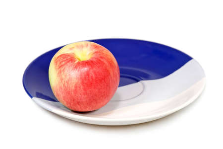 Red apple on the plate isolated on white background.の写真素材
