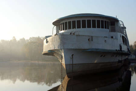 Abandoned and broken ship in morning haze.の写真素材