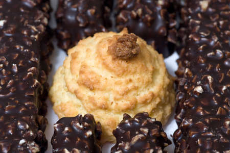 Coconut cookie is surrounded by chocolate waffles.の写真素材