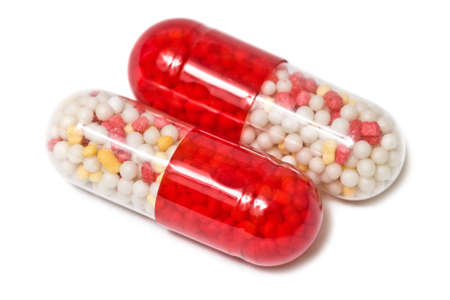 Closeup of red-white pills isolated on white background.の写真素材