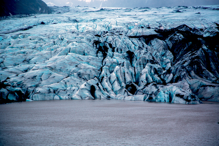 Solheimajokull glacier with blue ice with black ash inclusions