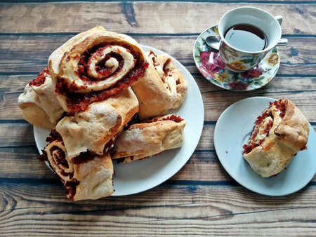 Bun with coffee. On the table there is a large plate with buns with coffee.の写真素材