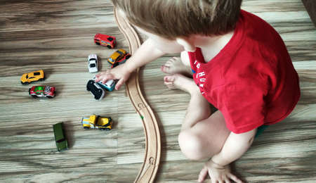 child playing with toy carの写真素材