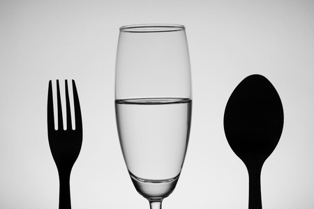 black and white vine glass with water spoon and forkの写真素材