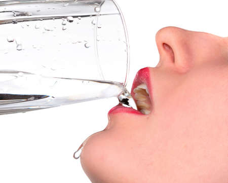 girl drank water, and droplet flow on chinの写真素材