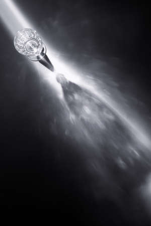 wine glass in light beam top view