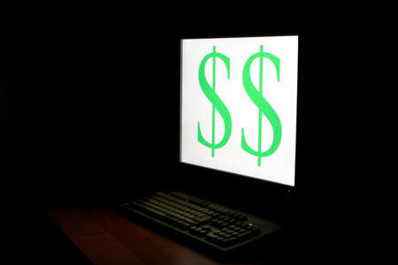 dollar sign on monitor in dark