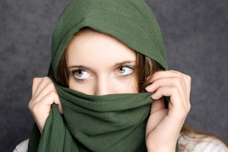 green scarf cover face of girlの写真素材