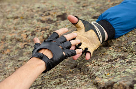 hand of one man help another man hand