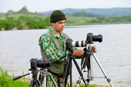 photographer prepare his gear to shootingの写真素材