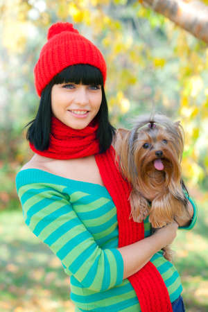 girl hold small dog in handsの写真素材