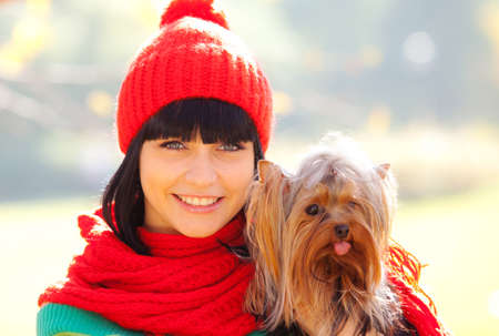 girl hold small dog in handsの写真素材