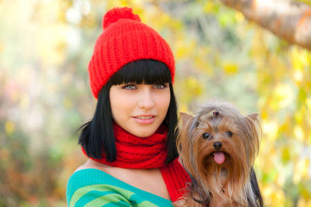 girl holds small dog in handsの写真素材