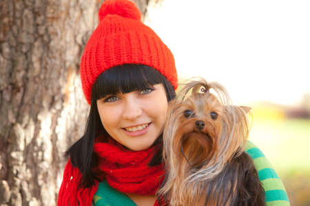 girl hold small dog in handsの写真素材