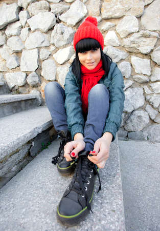 girl tie her laces on gymshoesの写真素材