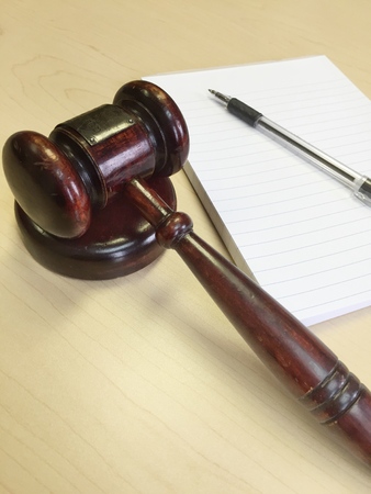 gavel and notepad with penの写真素材