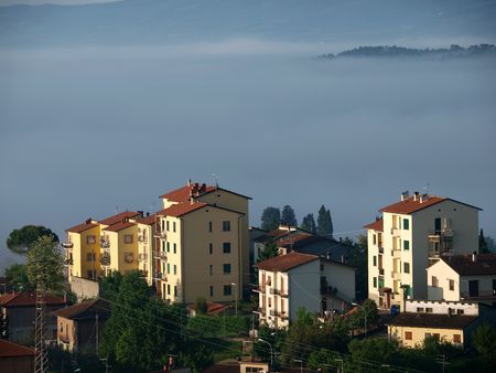 Fabulous landscape of the foggy morning in Tuscany. The valley between Montepulciano and Chiusiの写真素材