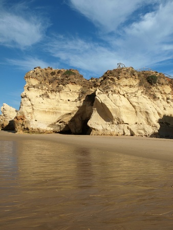 Caves and colourful rock formations on the Algarve coast in Portugal の写真素材