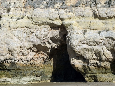 Caves and colourful rock formations on the Algarve coast in Portugalの写真素材