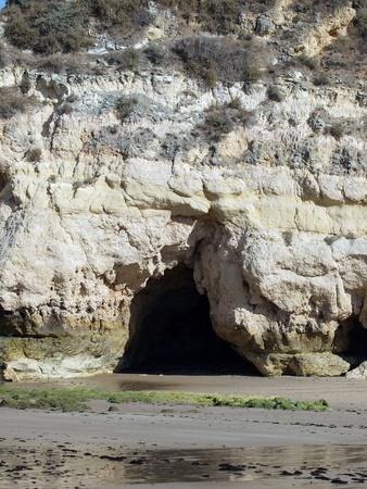 Caves and colourful rock formations on the Algarve coast in Portugalの写真素材