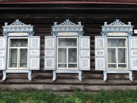 carved windows of old wooden house. 