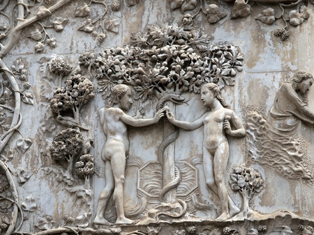 orvieto - Duomo facade. The first pillar: scenes from Genesis.Eve offers the forbidden fruit to Adam.の写真素材