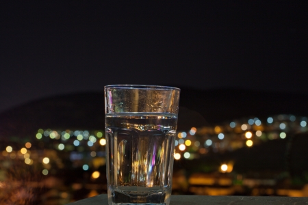 glass in front of defocused lights の写真素材