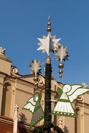 Christmas decorations with playing on trumpet angel on Main Market Square in Cracowの写真素材
