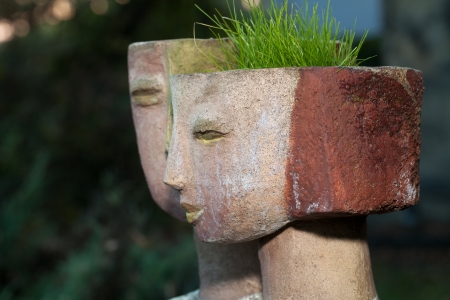 the flower pot in the form of the feminine headの写真素材