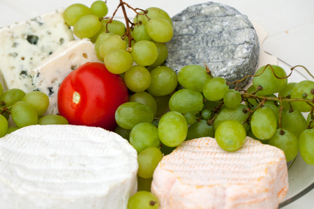Cheese with white grapes and tomatoの写真素材