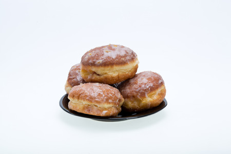  whole donuts on the black porcelain plate の写真素材