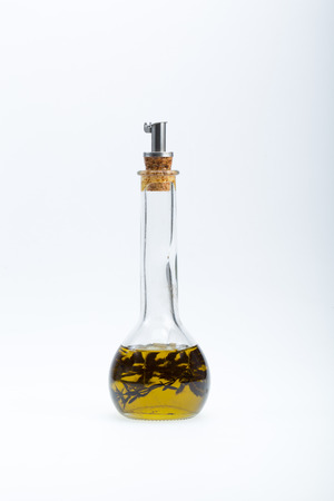 Thyme infused olive oil over white background の写真素材