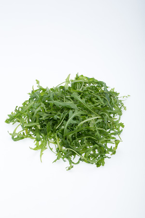 Heap of ruccola leaves isolated on white backgroundの写真素材
