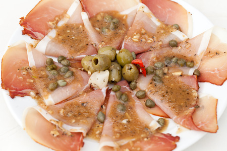 Prosciutto with olives and caperの写真素材