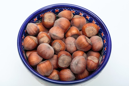 Pile of hazelnuts isolated on white background