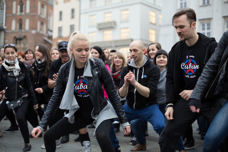 CRACOW, POLAND - MARCH 28, 2015:  the international Flashmob day of rueda de Casino,57 countries , 160 cities. Several hundred persons dance Hispanic rhythms on the Main Square in Cracowのeditorial素材