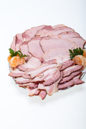 Plate of smoked meat isolated on white backgroundの写真素材