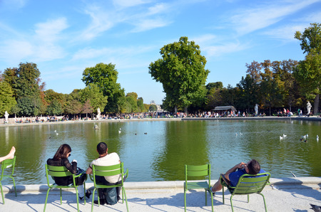Paris -  Local and Tourist in famous Tuileries garden. Tuileries Garden (Jardin des Tuileries) is a public garden located between the Louvre Museum and the Place de la Concorde. France.のeditorial素材