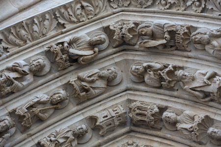 Paris - West facade of Notre Dame Cathedral. Archivolts of The Virgin Mary portalの写真素材
