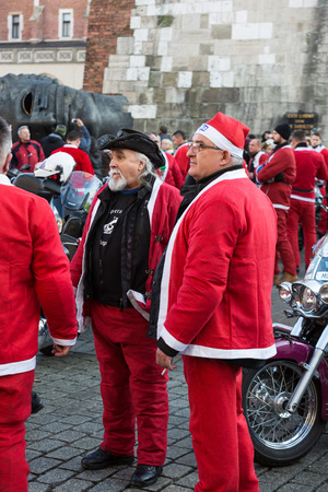 CRACOW, POLAND - DECEMBER 6, 2015: CRACOW, POLAND - DECEMBER 8, 2013: the parade of Santa Clauses on motorcycles around the Main Market Square in Cracow. Polandのeditorial素材
