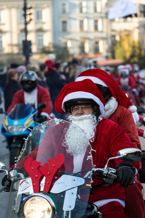 CRACOW, POLAND - DECEMBER 6, 2015: the parade of Santa Clauses on motorcycles around the Main Market Square in Cracow. Polandのeditorial素材