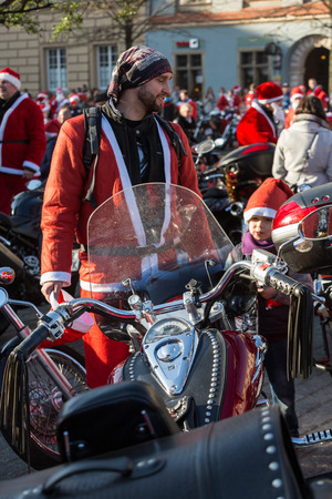 CRACOW, POLAND - DECEMBER 6, 2015: the parade of Santa Clauses on motorcycles around the Main Market Square in Cracow. Polandのeditorial素材